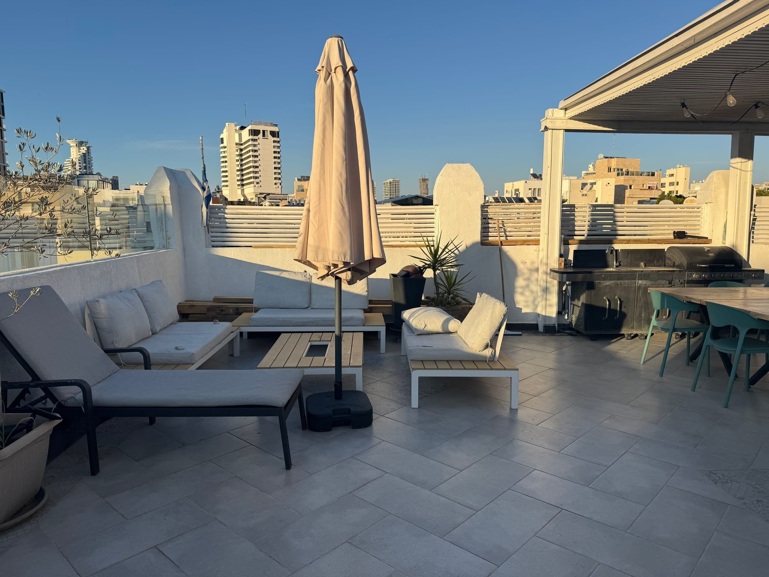 Or Hakerem penthouse terrace at sunset, set above central Tel Aviv